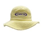 A yellow terry towelling bucket hat featuring a logo embroidered on the front.