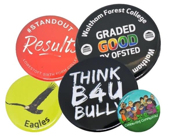 A collection of five button badges in various colours, featuring different designs and a logo on one badge. Button Badges 75mm - Image 1
