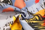 A patterned fabric with vibrant colours, featuring abstract designs in blue, yellow, red, and black.