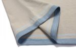A sports jumper in cream with light blue stripes and a branded logo on the hem.