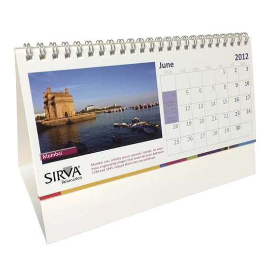 A wiro-bound tent desk calendar featuring a scenic image and a calendar grid, predominantly in white with colourful accents. A wiro-bound tent desk calendar featuring a scenic image and a calendar grid, predominantly in white with colourful accents.