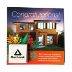 A card featuring a modern home image, with a small branded item in the corner. The card includes colourful floral designs.
