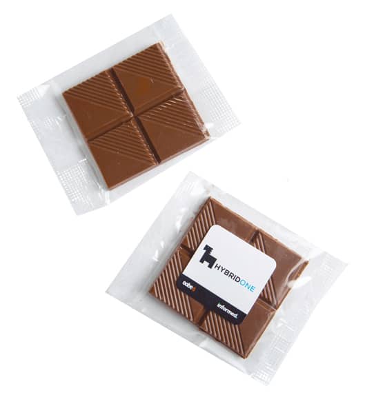 Chocolate squares wrapped in a clear cello bag, featuring a light brown colour with textured sections. Chocolate Square in Cello Bag 15g - Image 1