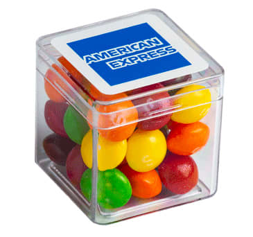 A transparent cube containing colourful Skittles in various shades, with a branding logo on the lid. Hard Cube with Skittles 40g - Image 1