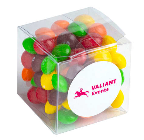 A clear cube filled with colourful Skittles in various shades of red, green, yellow, orange, and purple. A clear cube filled with colourful Skittles in various shades of red, green, yellow, orange, and purple.