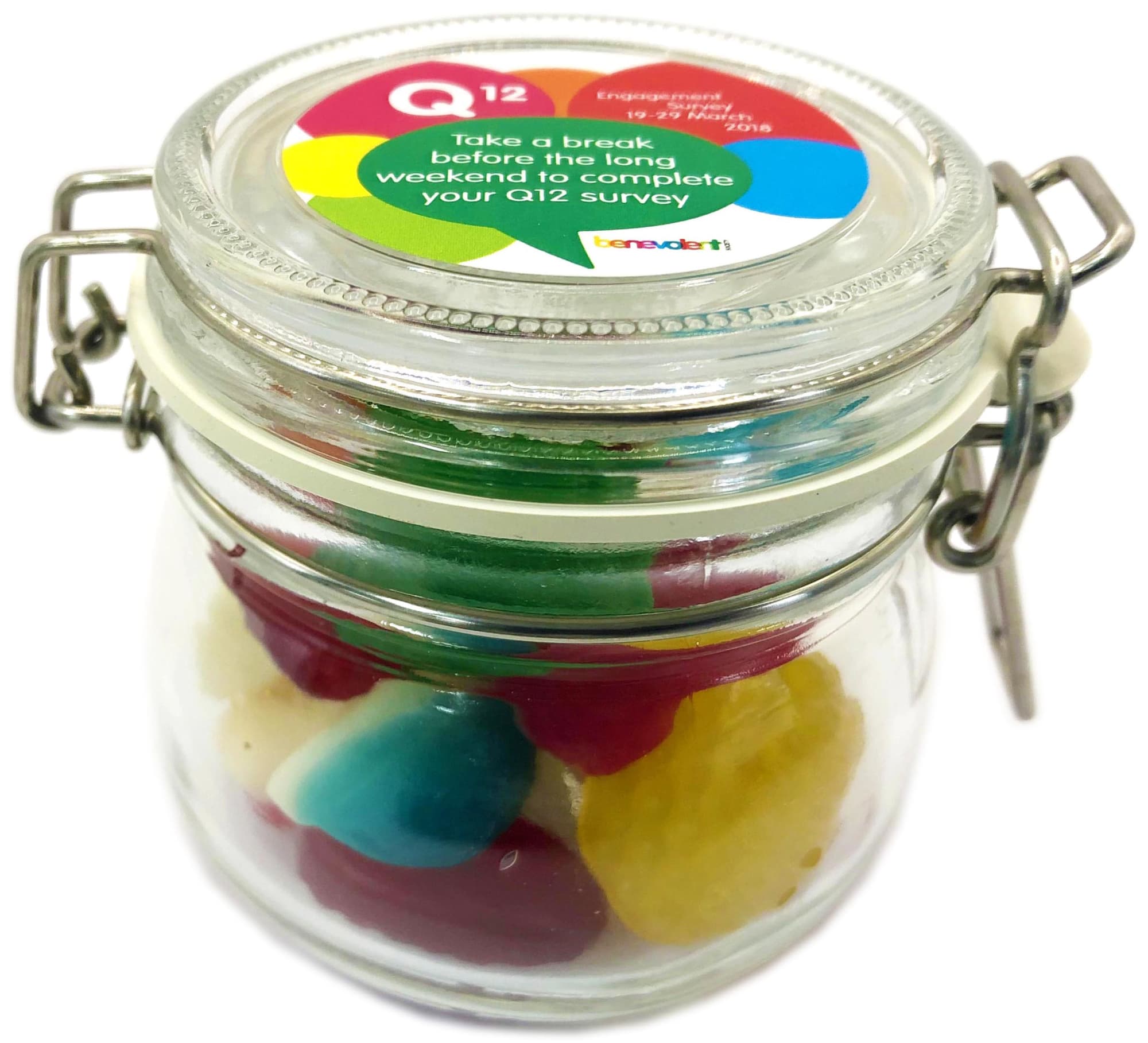 A glass canister filled with mixed lollies in various colours, including red, green, blue, and yellow. Small Canister with Mixed Lollies 120g - Image 1