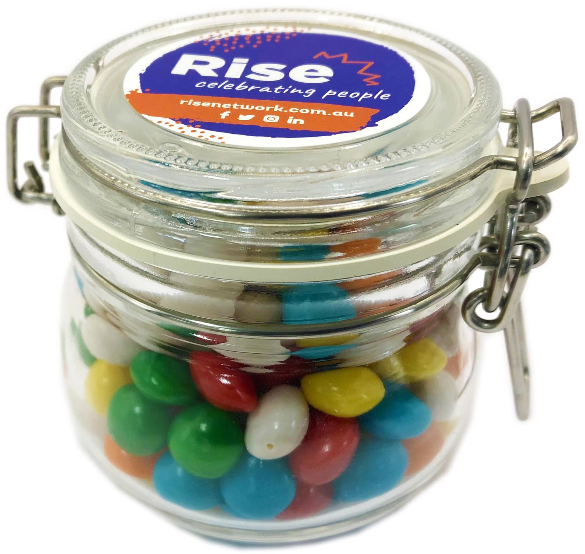 A glass canister filled with colourful chewy fruit candies, featuring a metal clasp and a logo on the lid. Small Canister with Chewy Fruits 130g - Image 1