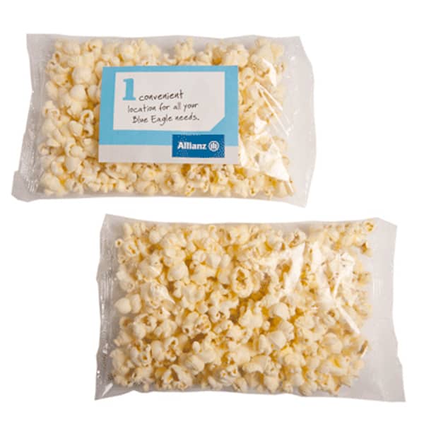 A clear plastic bag containing light yellow buttered popcorn, featuring a logo on the packaging. Buttered Popcorn 30G - Image 1