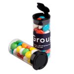 A transparent flip lid tube filled with colourful chewy fruit sweets, featuring a branding label on the side.