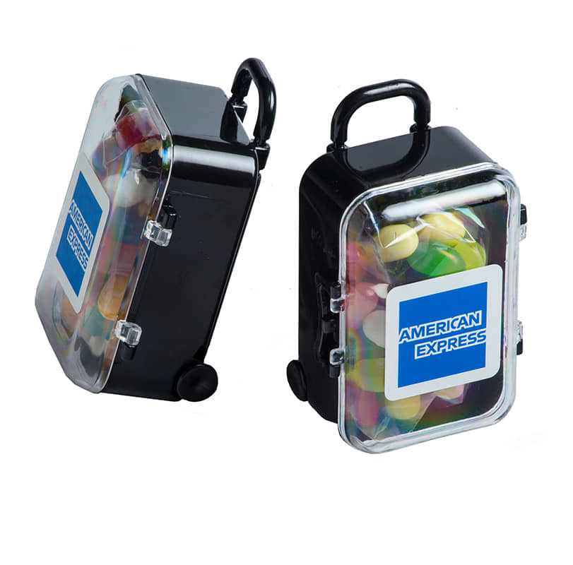 A black carry-on case filled with a variety of colourful JELLY BELLY jelly beans, featuring a handle and wheels. Carry-On Case with JELLY BELLY Jelly Beans 50g - Image 1