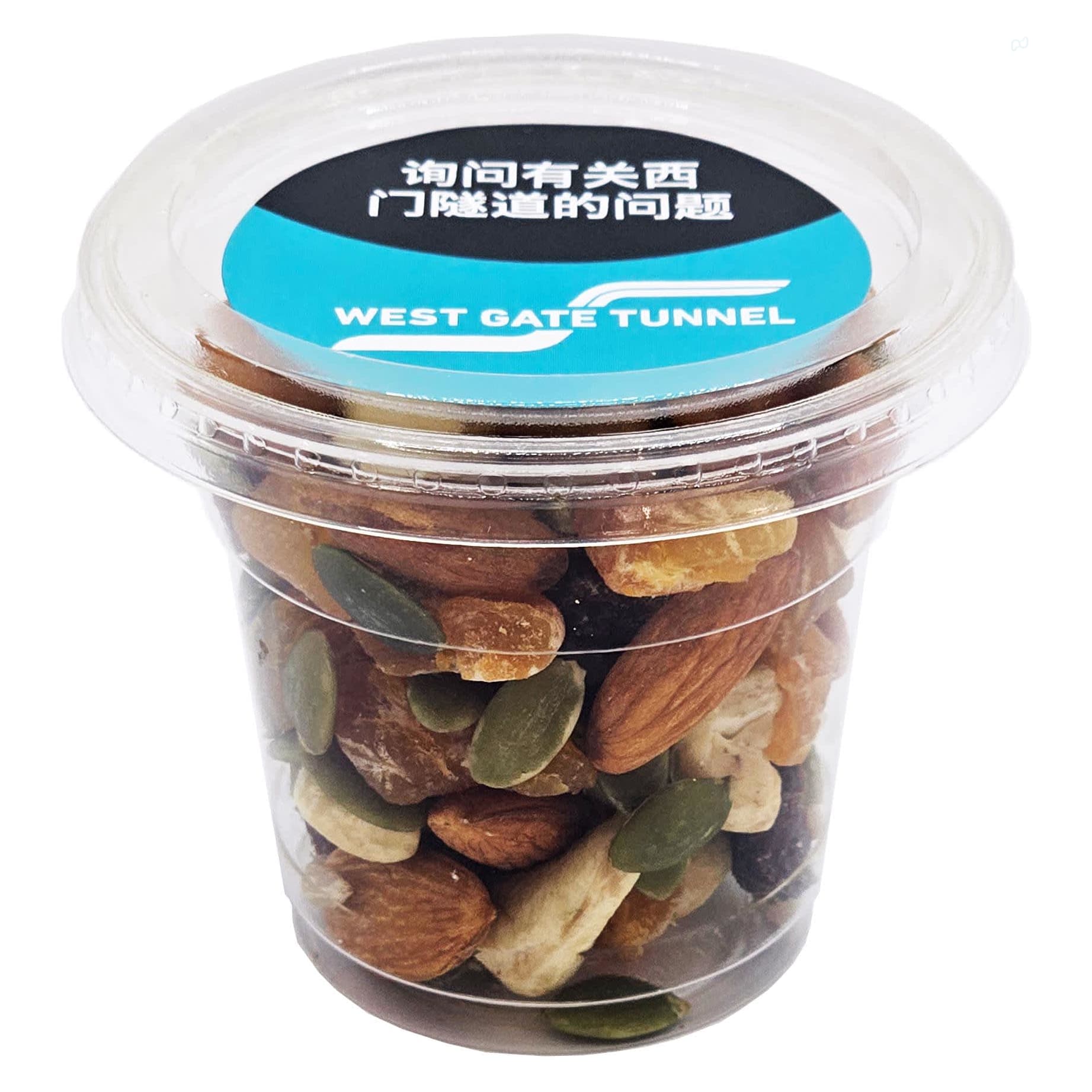 A clear cup filled with a mix of dried fruits, nuts, and seeds, featuring brown, green, and beige colours. Tub filled with Dried Fruit Mix - Image 1