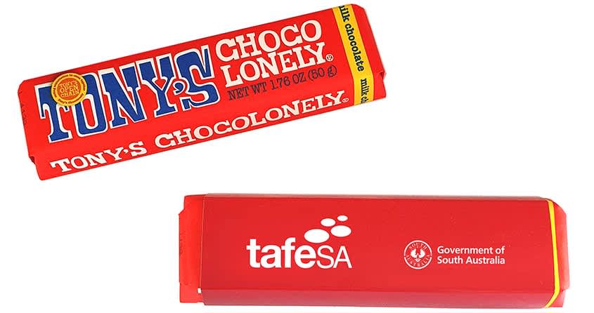 A red chocolate bar sleeve featuring branding, containing Tony's Chocolonely 50g chocolate. Tony's Chocolonely 50g with Sleeve - Image 1