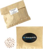 A kraft paper bag containing white mints, accompanied by another bag with a logo.