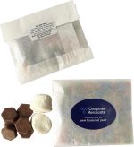 A kraft paper bag containing chocolate buttons and marshmallows, featuring a logo and a label on the packaging.