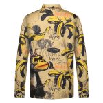 A sports jumper with a vibrant banana and monkey print design, featuring long sleeves and a collar.