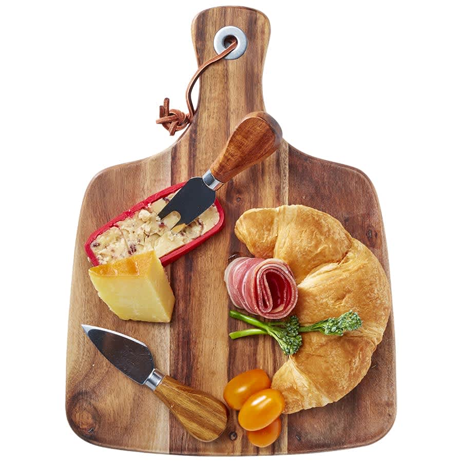 Acacia cheeseboard with knife set, featuring a wooden board, cheese, cured meats, croissant, and cherry tomatoes. Acacia Cheeseboard & Knife Set - Image 1
