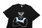 A black cotton t-shirt featuring a large, stylised graphic of a muscular figure on the front, with a logo on one sleeve.