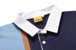 A sports jumper featuring a navy blue body, light blue sleeves, and a white collar, with a branding label.