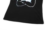A black cotton t-shirt featuring a printed design with a logo on it, showcasing a close-up view of the fabric.
