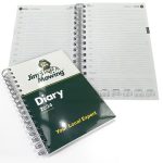 A5 wiro-bound diary with a green printed cover, featuring 157 leaves and a day-per-page layout.