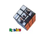 A Rubik's Cube 3x3, featuring black and orange colours, with an attached logo and images on some panels.