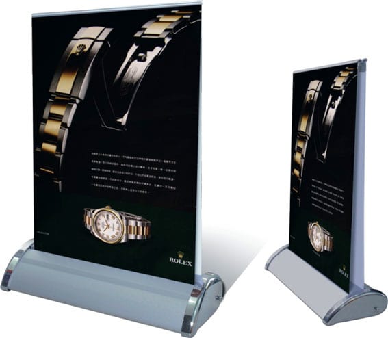 A double-sided pull-up banner featuring a black background and a gold and silver design, with a logo. Table Top Pull Up Banner A4 Double Sided - Image 1