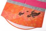 A Hawaiian shirt featuring vibrant orange fabric with turtle designs, complemented by a pink and grey collar.