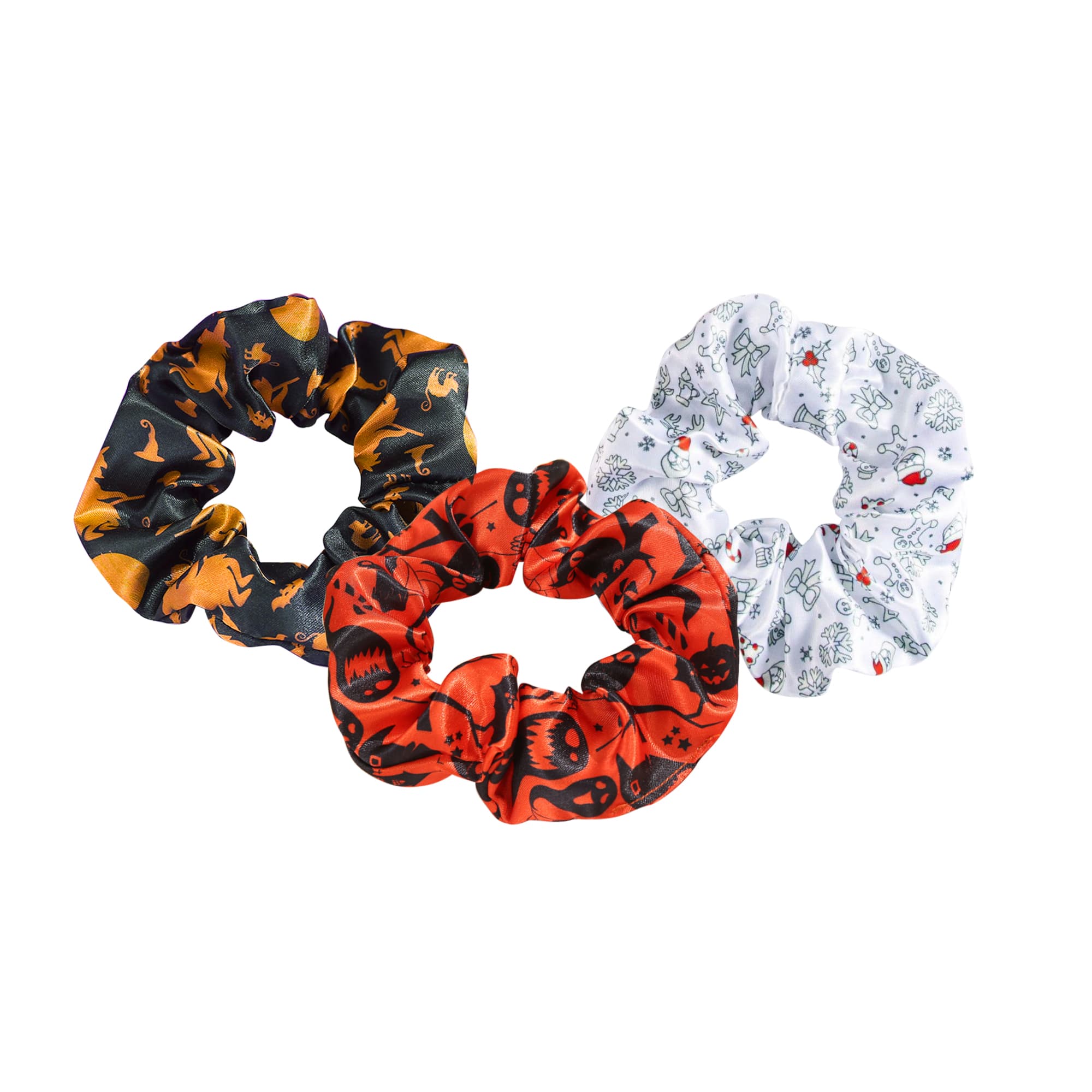 Three hair scrunchies in black with orange patterns, red with skulls, and white with playful designs, featuring a logo. Hair Scrunchie - Image 1