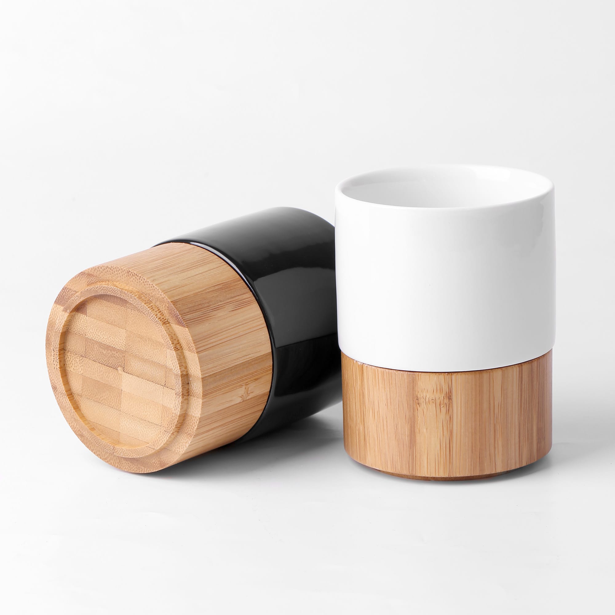 A black and white mug with bamboo bases, featuring a sleek, modern design. Includes a logo on the mug. Cerabam Mug - Image 1