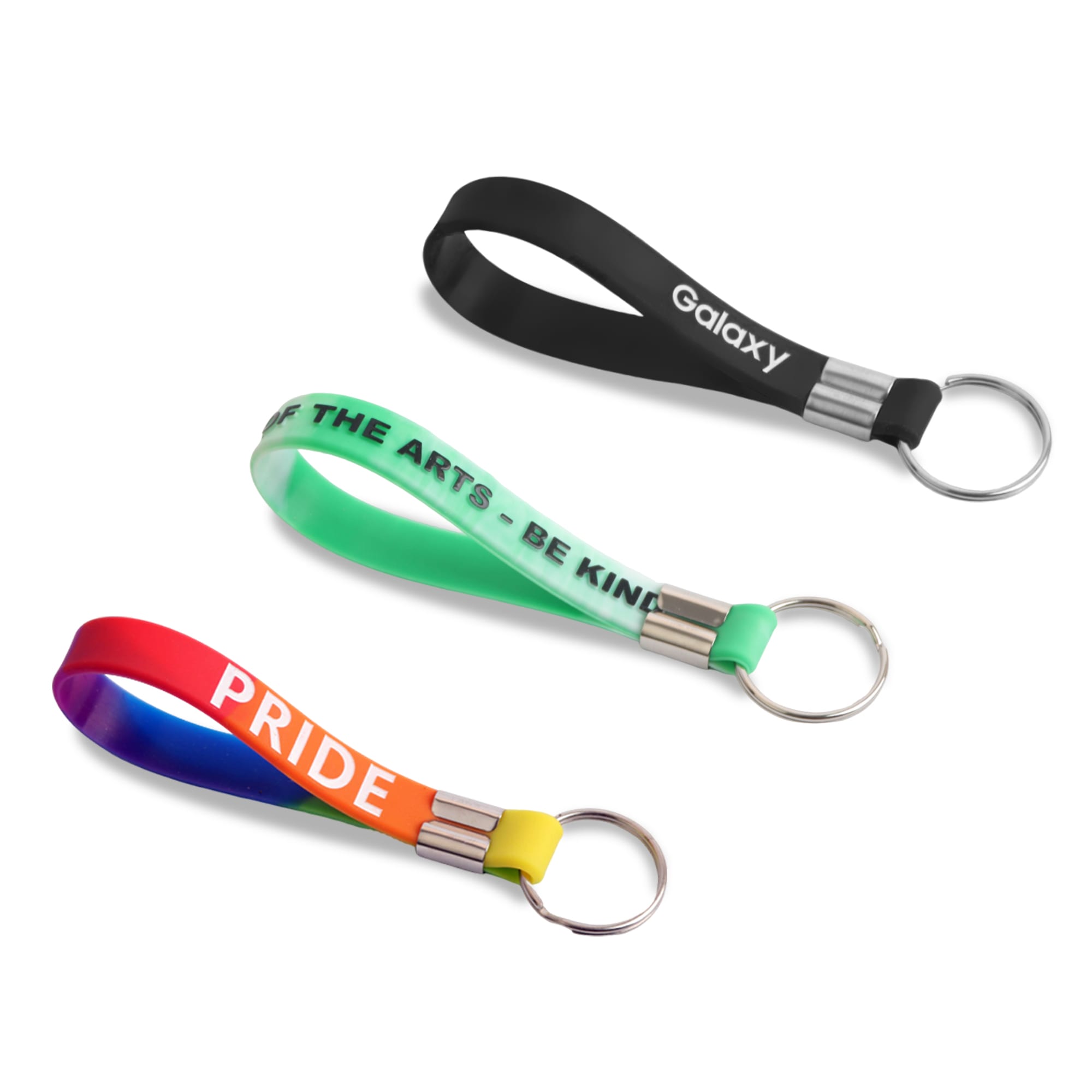Three silicone key rings in black, green, and a rainbow gradient, each featuring metallic keyring attachments. Silicone Key Ring - Image 1
