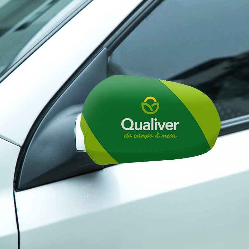 A green and yellow car mirror cover with a logo, designed for sedans, positioned on a silver car. Car Mirror Cover (Sedan) - Image 1