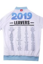 A white sports jumper with a light blue collar, featuring a list of names and a logo.
