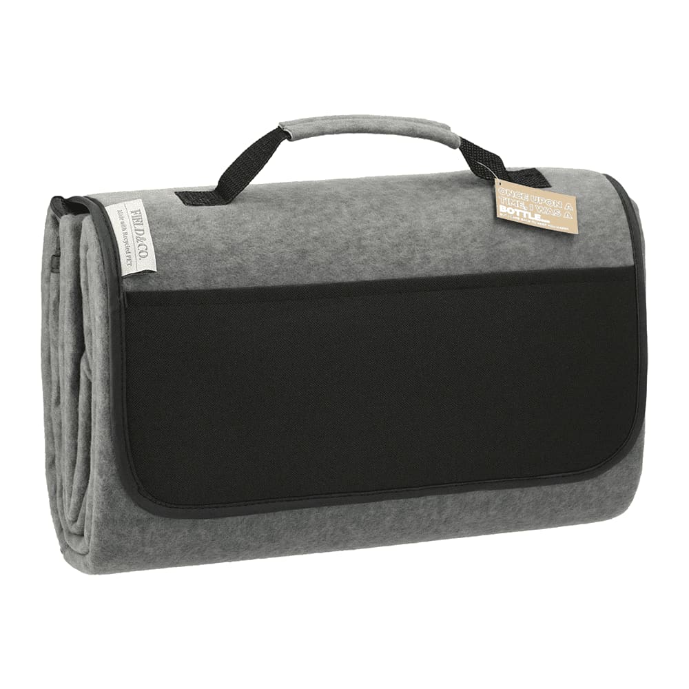 A grey oversized picnic rug with a handle, featuring a black pocket and a logo on the side. A grey oversized picnic rug with a handle, featuring a black pocket and a logo on the side.