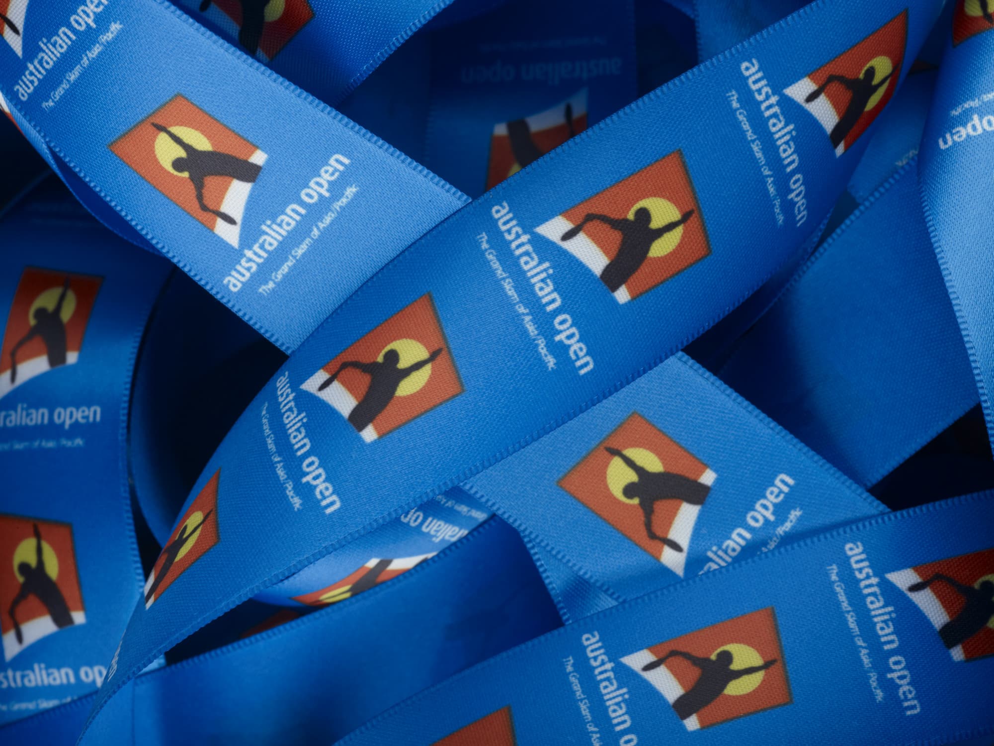 Blue ribbon with printed logos, featuring the Australian Open design, custom dyed to specific PMS colour. Custom Exact Colour Matched Print on Ribbon Dyed to PMS Colour 15mm - Image 1