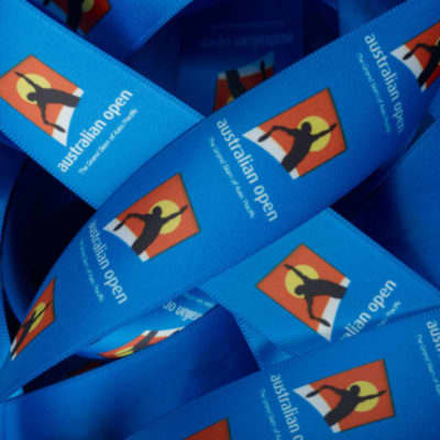 A blue ribbon with a repeated logo design, showcasing vivid colours and patterns, featuring the text "australian open". Custom Exact Colour Matched Print on Ribbon Dyed to PMS Colour 7mm - Image 1