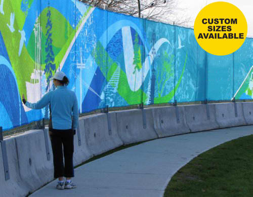 A woman interacts with a vibrant, multi-coloured mesh polyester banner along a curved pathway. The banner features abstract designs and a logo. Mesh Polyester Banner - Image 1
