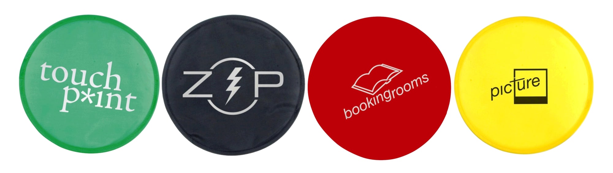Four circular Frisbees in green, black, red, and yellow, each featuring a different logo or branding element. Flexi Flyer, INDENT - Image 1