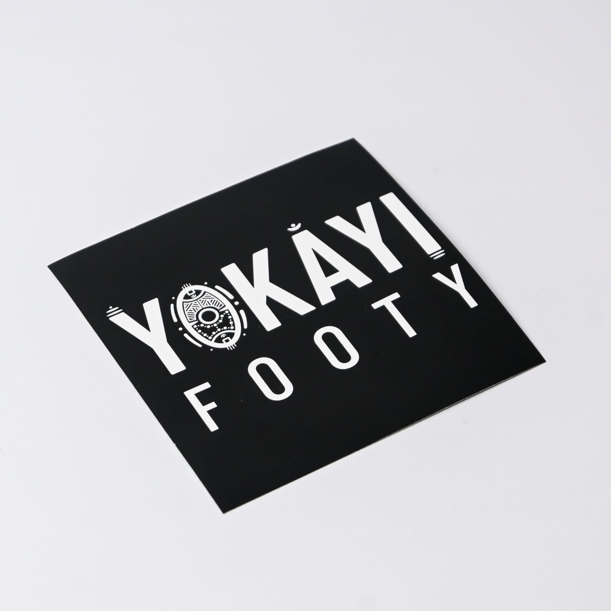 A square gloss paper sticker featuring a black background with white text and a logo. Gloss Paper Sticker (75 x 75 mm) - Image 1