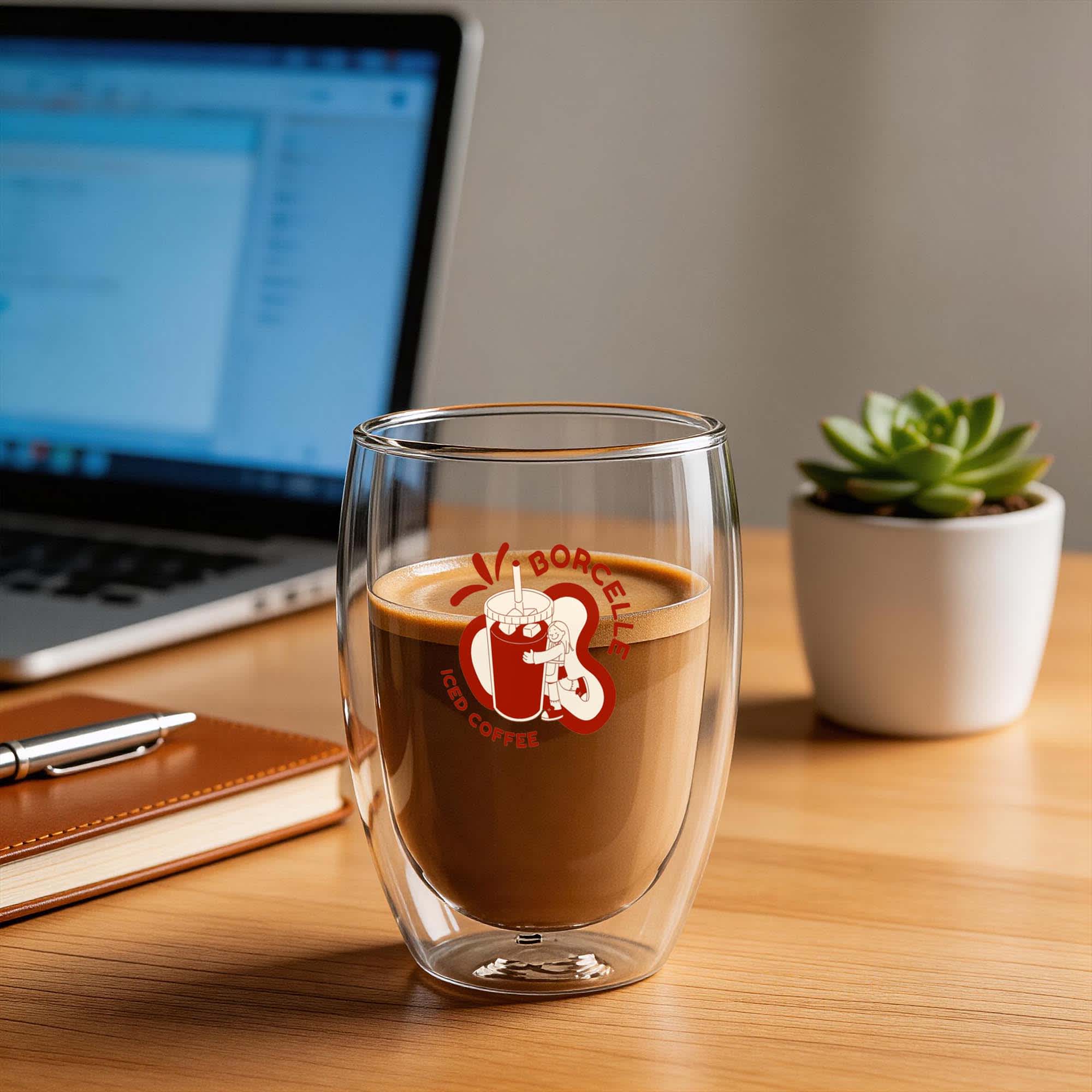 A double wall glass with a curved design, containing coffee. The glass is clear, showcasing the beverage inside. Tolini Double Wall Glass 340ml - Image 1