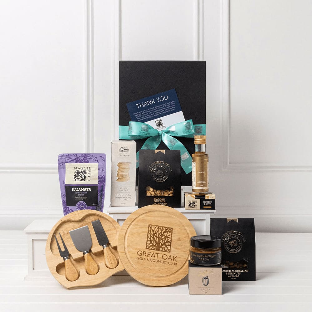 A gourmet entertainer set featuring wooden cheese tools, gourmet snacks, a bottle, and a gift box adorned with a ribbon. The Custom Gourmet Entertainer Set - Image 1