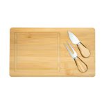 A bamboo cheese board with a clear section and two stainless steel utensils with wooden handles.