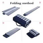 A picnic blanket in a checkered pattern, displayed in various stages of folding. It has a dark carry handle.