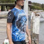 A men's fishing tee featuring a blue and black design with a fish graphic and a logo on the sleeve.