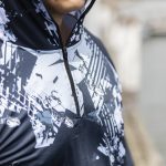 A men's polyester sublimated 1/4 zip fishing hoodie in dark blue with a graphic design and a logo.