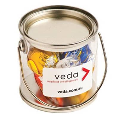 A small silver PVC bucket filled with colourful Lindt chocolate balls. The bucket features a handle and a logo label. A small silver PVC bucket filled with colourful Lindt chocolate balls. The bucket features a handle and a logo label.