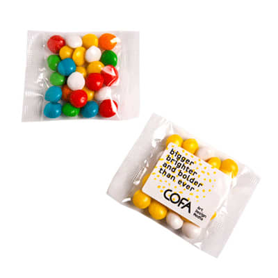 A packet of chewy fruit sweets in vibrant colours, including red, yellow, green, blue, and white, with a logo. Chewy Fruits 25g - Image 1