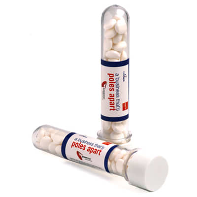 Test tubes filled with white mints, featuring a clear container and a white cap. One tube is upright, the other is lying down. Test Tube with Chewy Mints 40g - Image 1