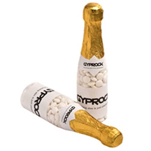 A drink bottle resembling a champagne bottle, filled with white mints, featuring gold foil and branding. Champagne Bottle with Chewy Mints 220g - Image 1