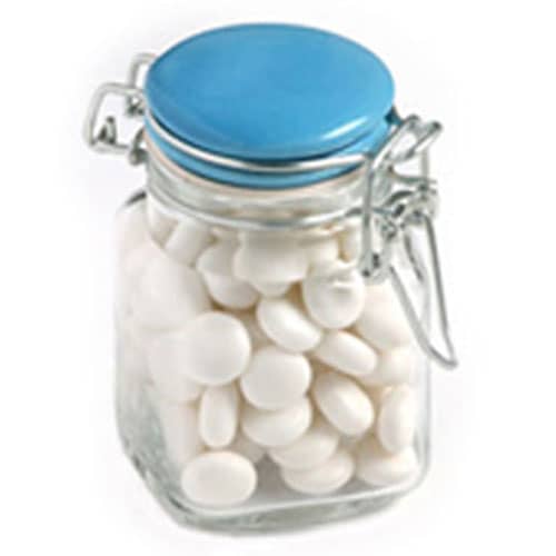 A glass jar with a blue lid, filled with white chewy mints. The jar features a metal clasp. Clip Lock Jar with Chewy Mints 80g - Image 1