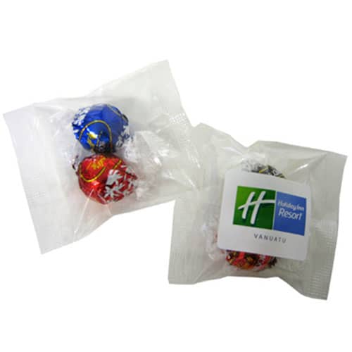 Two wrapped chocolate balls in red and blue packaging, accompanied by a logoed label. Lindor Balls x2 - Image 1